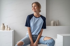 Woman wearing light blue and dark blue raglan shirt Product Image 1