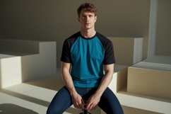 Man wearing teal and black raglan t-shirt Product Image 1