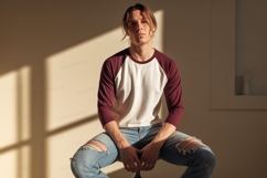Young man wearing maroon and cream baseball shirt image Product Image 1