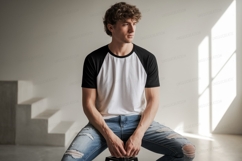 Man wearing baseball shirt ripped jeans white black Product Image 1