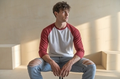 Young man wearing baseball shirt and ripped jeans male Product Image 1