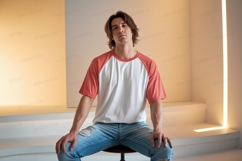 Young man wearing baseball tee and ripped jeans image Product Image 1