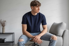 Man wearing navy t shirt ripped jeans image Product Image 1