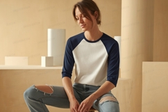Woman wearing baseball shirt and ripped jeans image Product Image 1