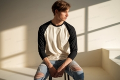 Young man wearing baseball shirt and ripped jeans image Product Image 1