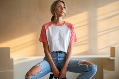 Woman wearing coral and white t shirt ripped jeans Product Image 1