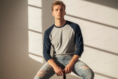 Young man wearing baseball shirt and ripped jeans male Product Image 1