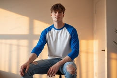 Young man wearing blue white baseball shirt ripped jeans Product Image 1