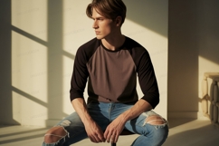 Young man wearing baseball shirt and ripped jeans image Product Image 1