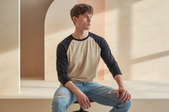 Young man wearing baseball shirt and ripped jeans raglan Product Image 1