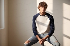 Young man wearing baseball shirt and ripped jeans male Product Image 1