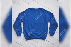 Blue Tshirt Mockup On A Wooden Surface Product Image 1