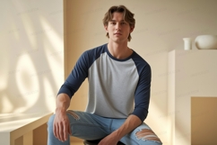 Young man wearing baseball shirt and ripped jeans male Product Image 1