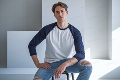 Man wearing baseball shirt and ripped jeans navy white Product Image 1