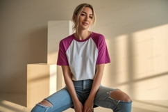 Woman wearing baseball tee and ripped jeans image Product Image 1