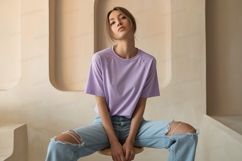 Woman wearing lavender t shirt ripped jeans image Product Image 1