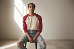 Man wearing baseball shirt and ripped jeans image Product Image 1