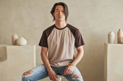 Man wearing two tone raglan shirt and ripped jeans Product Image 1