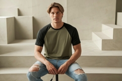 Man wearing olive green black raglan shirt ripped jeans Product Image 1