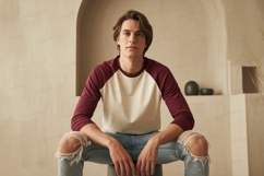 Young man wearing baseball shirt ripped jeans maroon Product Image 1