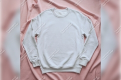 White Sweatshirt On Pink Fabric Background Product Image 1