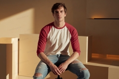 Young man wearing baseball tee and ripped jeans Product Image 1