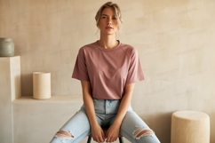 Woman wearing pink shirt ripped jeans image Product Image 1