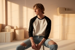 Young man wearing baseball shirt and ripped jeans image Product Image 1