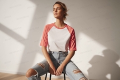 Woman wearing white coral raglan t shirt ripped jeans Product Image 1