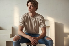 Young man wearing beige t shirt ripped jeans image Product Image 1