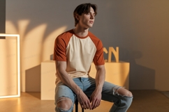 Young man wearing raglan t shirt and ripped jeans image Product Image 1