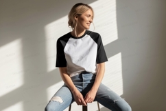 Woman wearing white black raglan shirt ripped jeans Product Image 1