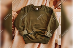 Olive Green Sweatshirt On Cozy Blanket Tshirt Mockup Product Image 1