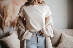 Woman wearing cream t shirt light blue jeans image Product Image 1
