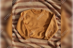 Mustard Sweatshirt On Striped Brown Textile Tshirt Mockup Product Image 1
