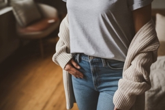 Woman wearing grey t shirt blue jeans beige cardigan Product Image 1