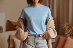 Woman wearing light blue t shirt and beige cardigan Product Image 1
