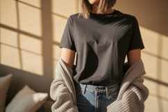 Woman wearing dark grey t shirt and blue jeans image Product Image 1