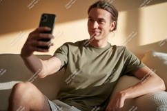Man taking selfie on couch phone casual Product Image 1