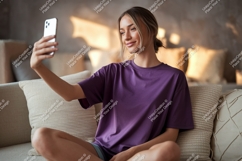 Woman taking selfie on couch phone indoor Product Image 1