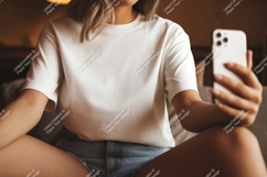Woman wearing white t shirt holding phone image Product Image 1