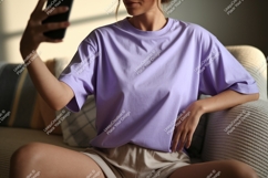 Woman wearing lavender t shirt holding phone image Product Image 1