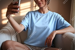 Woman taking selfie in light blue t shirt phone Product Image 1