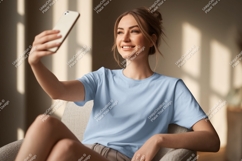 Woman taking selfie with phone blue t-shirt Product Image 1