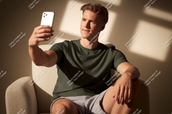 Man taking selfie in armchair phone casual Product Image 1