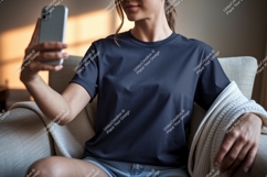Woman wearing dark blue t shirt taking selfie image Product Image 1