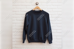 Dark Blue Sweatshirt On White Brick Wall Product Image 1