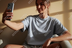 Woman taking selfie wearing grey t shirt phone Product Image 1