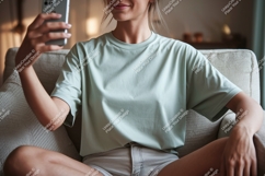 Woman holding phone wearing t shirt casual Product Image 1