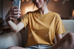 Woman wearing mustard shirt taking selfie phone Product Image 1